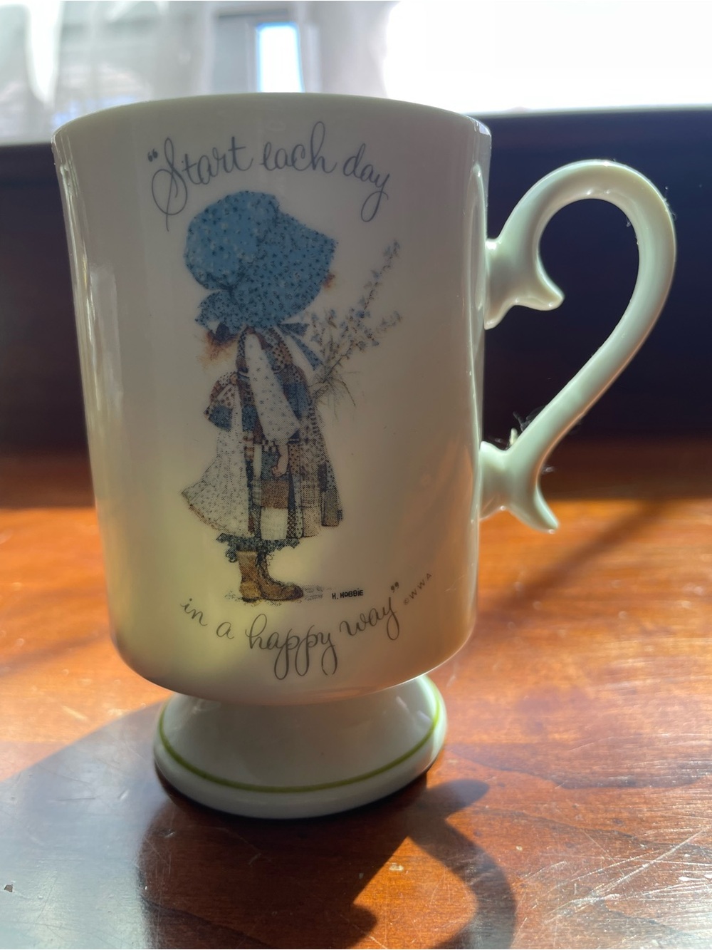Holly Hobbie Ceramic Pedestal Mug in Cream with Blue Graphic
